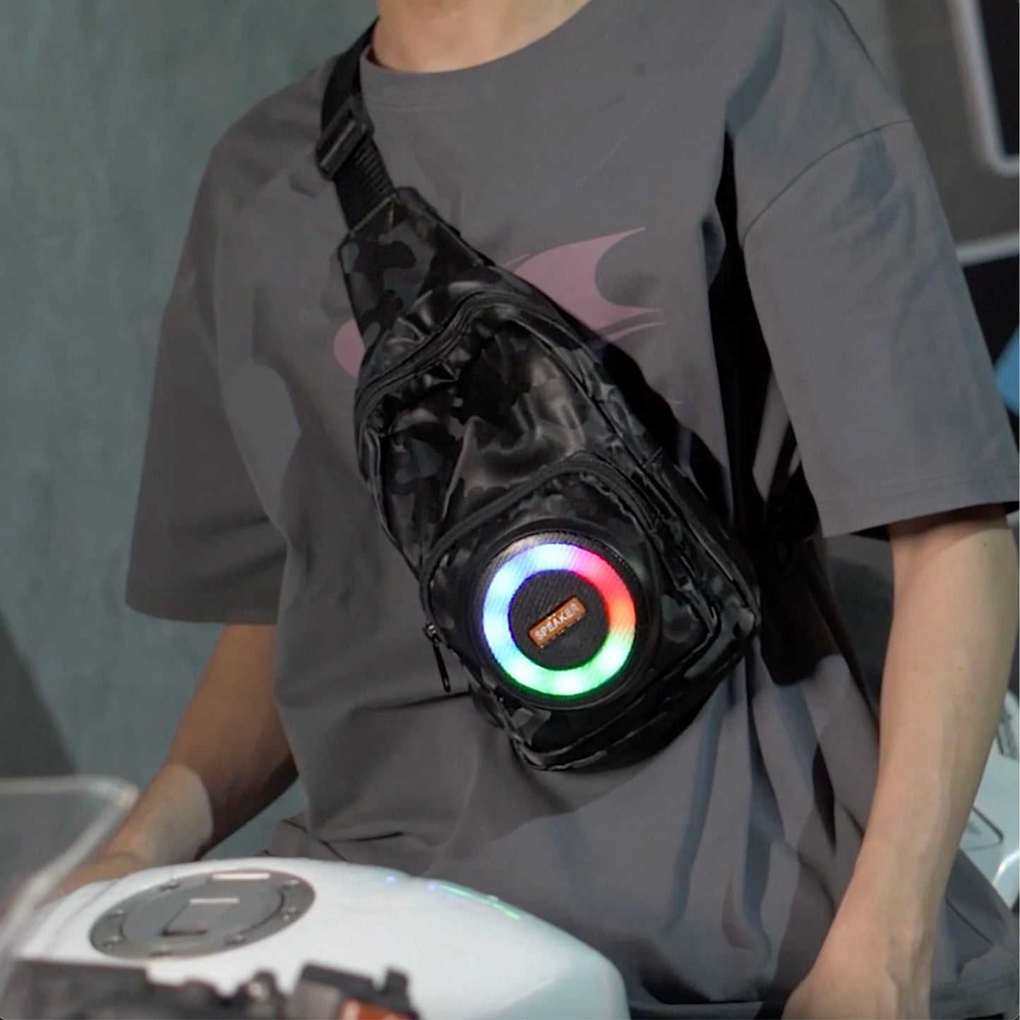 Person wearing a black bag with colorful LED lights on a gray background